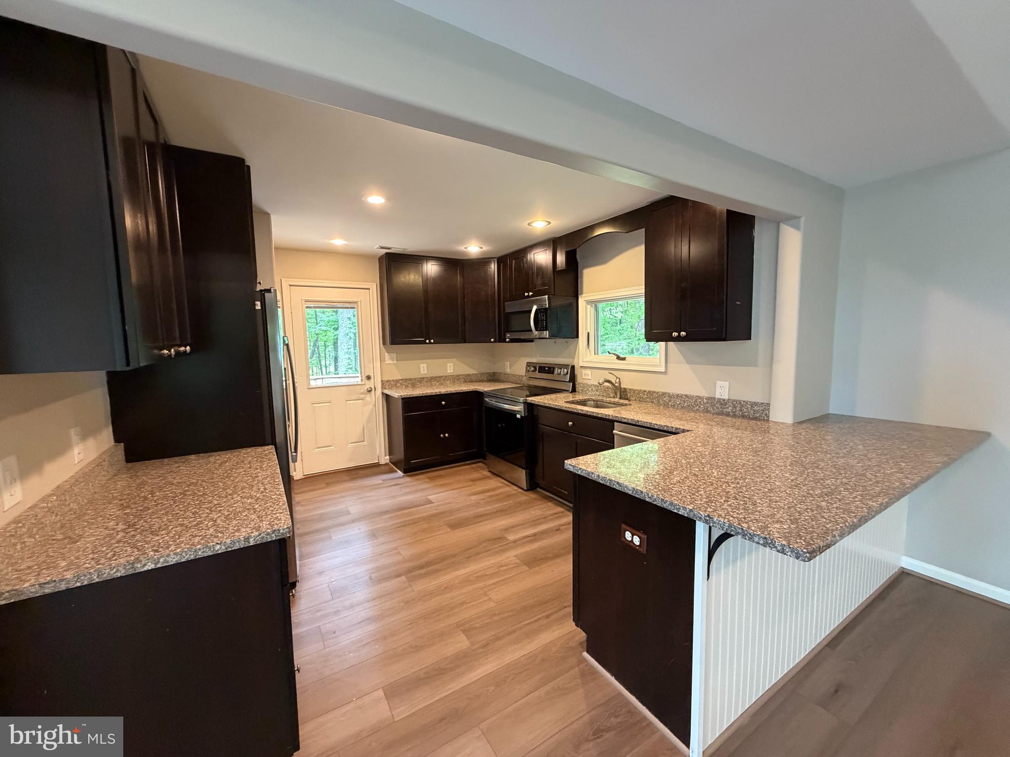 146 Trillium Trail Road Linden, VA 22642 - Photo 7 of 21 a kitchen with stainless steel appliances granite countertop a sink stove and refrigerator