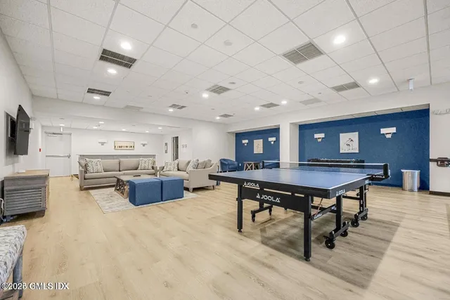 a living room with furniture a table and kitchen view