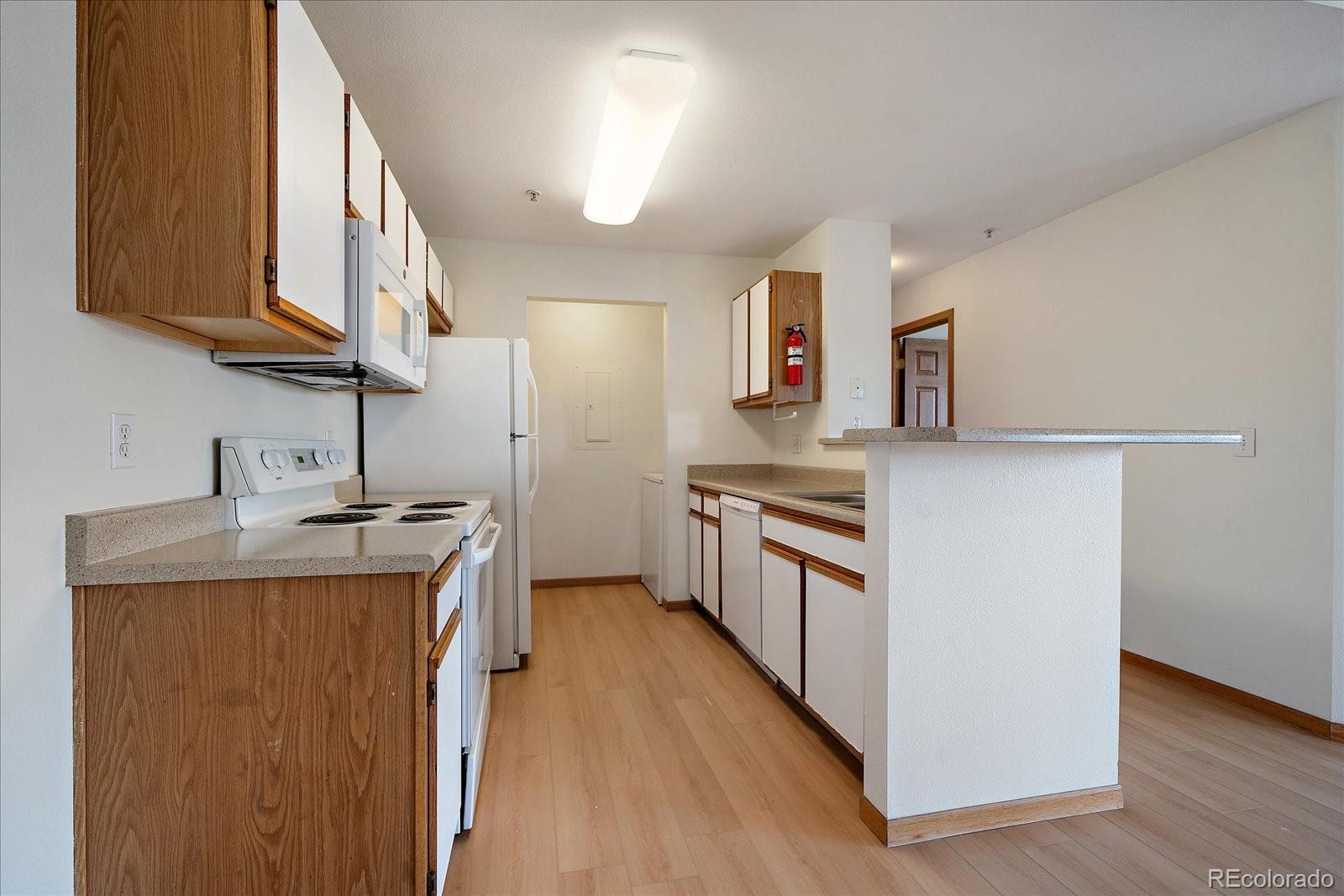 2226 West Elizabeth Street, Unit D302 Fort Collins, CO 80521 - Photo 12 of 20 a kitchen with stainless steel appliances granite countertop a sink stove and refrigerator