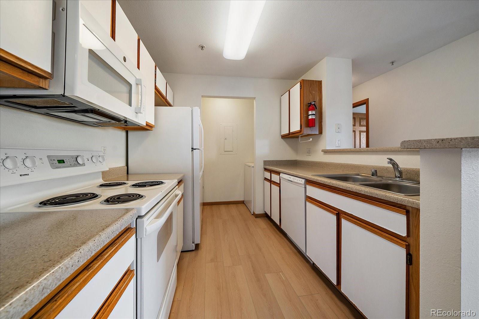 2226 West Elizabeth Street, Unit D302 Fort Collins, CO 80521 - Photo 13 of 20 a kitchen with stainless steel appliances granite countertop a stove and a sink