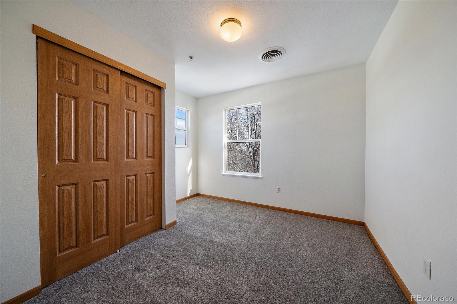 2226 West Elizabeth Street, Unit D302 Fort Collins, CO 80521 - Photo 17 of 20 an empty room with windows