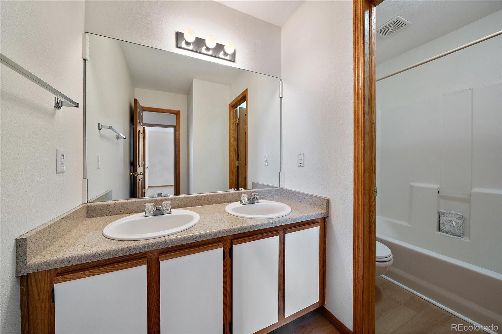2226 West Elizabeth Street, Unit D302 Fort Collins, CO 80521 - Photo 18 of 20 a bathroom with a sink and a mirror