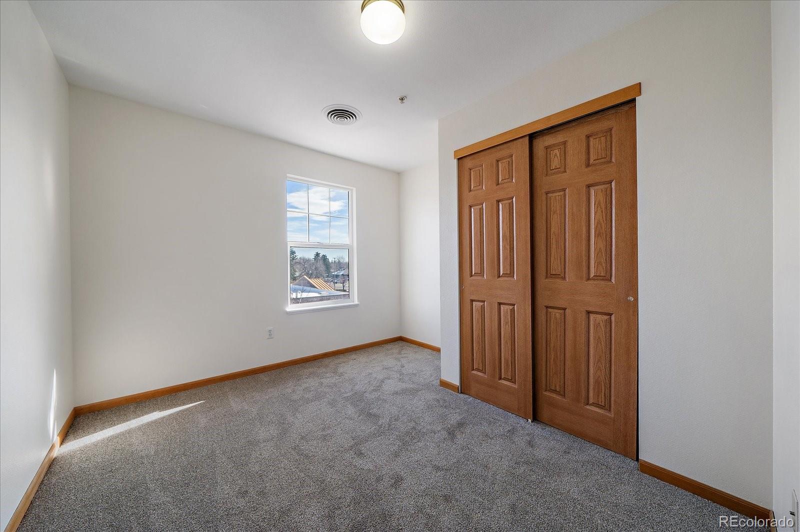 2226 West Elizabeth Street, Unit D302 Fort Collins, CO 80521 - Photo 19 of 20 an empty room with windows and closet