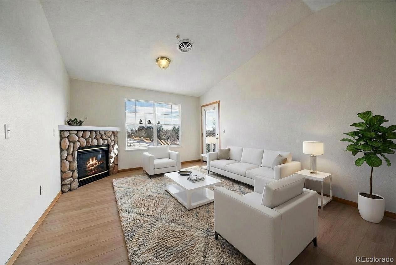 2226 West Elizabeth Street, Unit D302 Fort Collins, CO 80521 - Photo 2 of 20 a living room with furniture flower pot and a fireplace