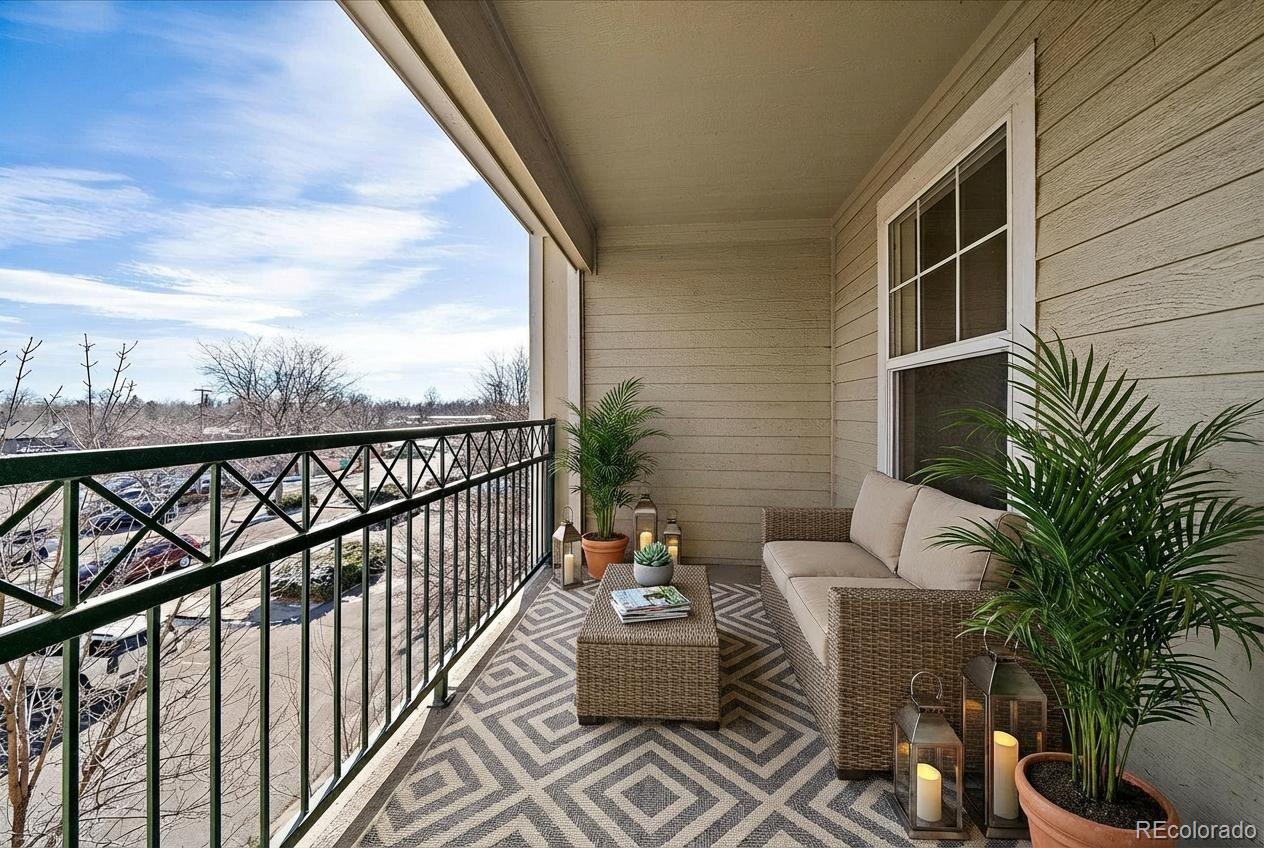 2226 West Elizabeth Street, Unit D302 Fort Collins, CO 80521 - Photo 4 of 20 a balcony with furniture and potted plants