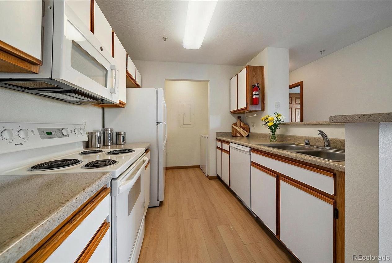 2226 West Elizabeth Street, Unit D302 Fort Collins, CO 80521 - Photo 5 of 20 a kitchen with stainless steel appliances granite countertop a sink stove and cabinets