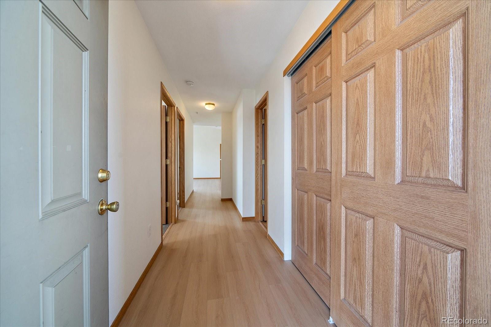 2226 West Elizabeth Street, Unit D302 Fort Collins, CO 80521 - Photo 6 of 20 a view of a hallway with wooden floor and a stairs