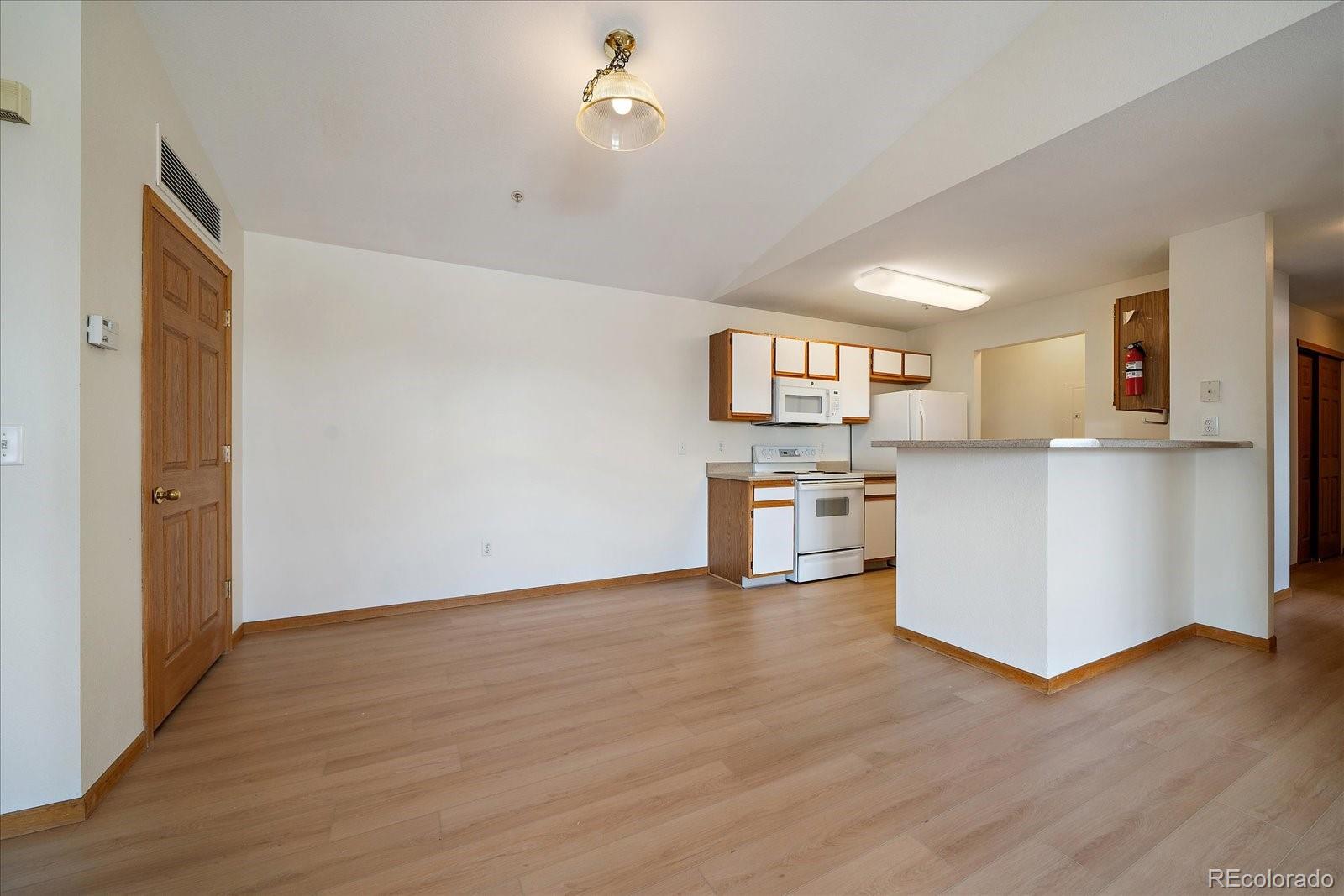 2226 West Elizabeth Street, Unit D302 Fort Collins, CO 80521 - Photo 10 of 20 a view of kitchen with wooden floor