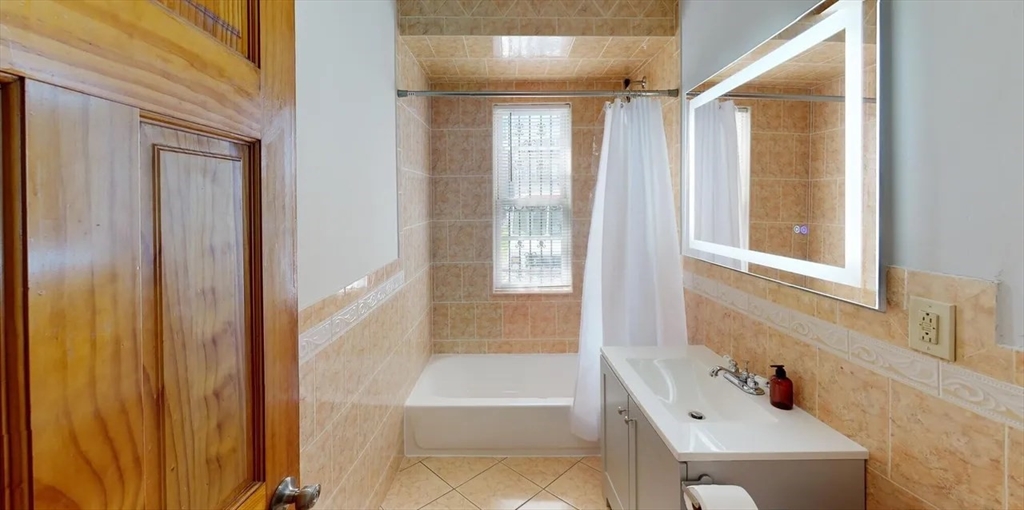 6 Cawfield Street, Unit 3 Boston, MA 02125 - Photo 8 of 9 a bathroom with a tub shower and sink