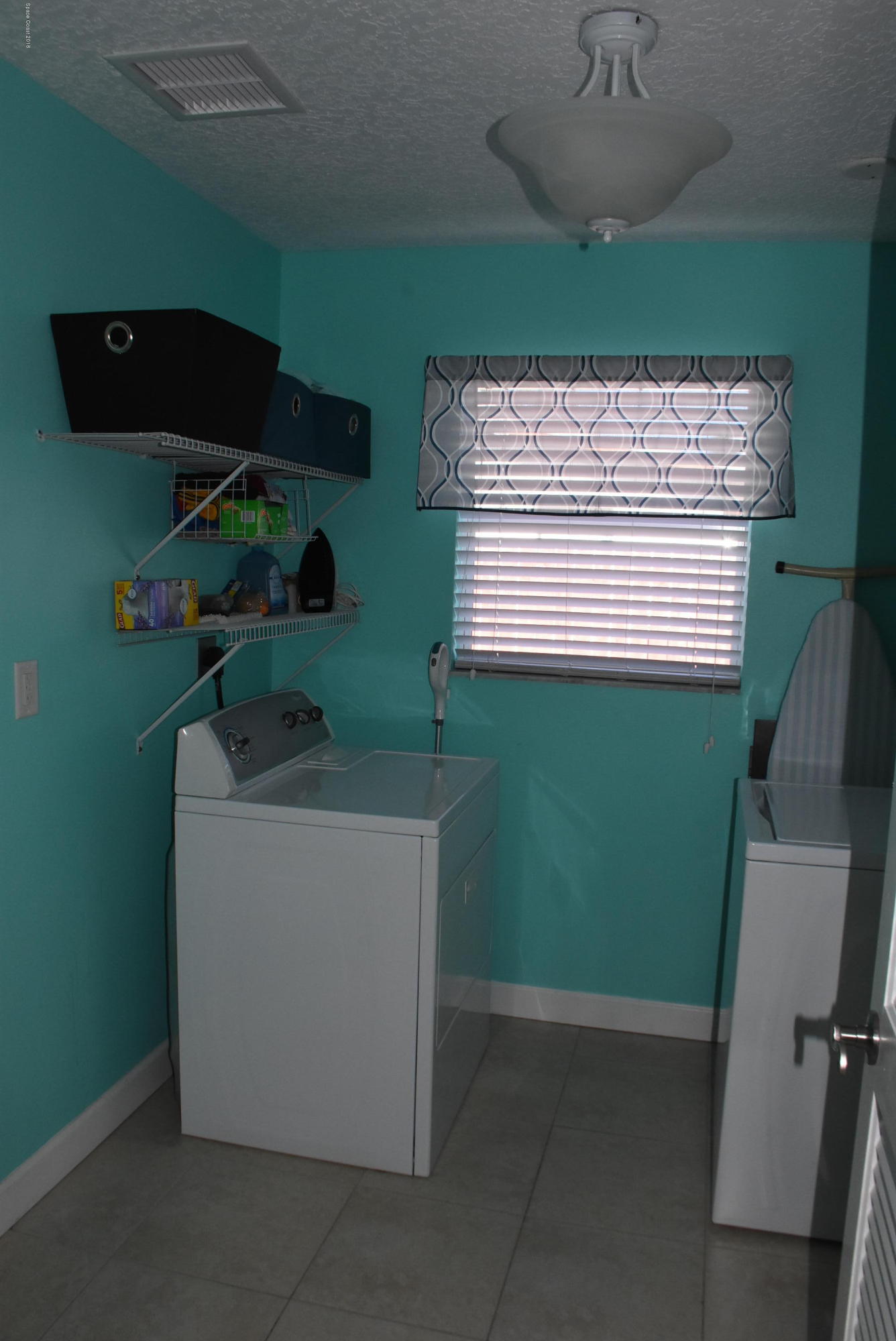 1101 Basque Drive Rockledge, FL 32955 - Photo 22 of 29 a utility room with a sink a washer and dryer
