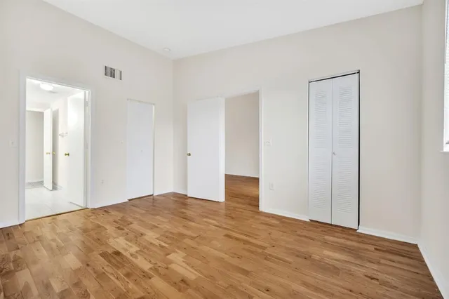 a view of a room with wooden floor and bathroom