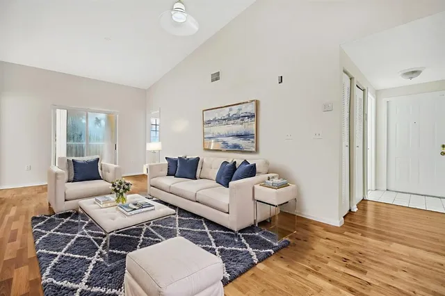 a living room with furniture a rug and a table