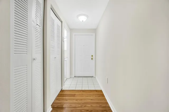 a view of a hallway with wooden floor
