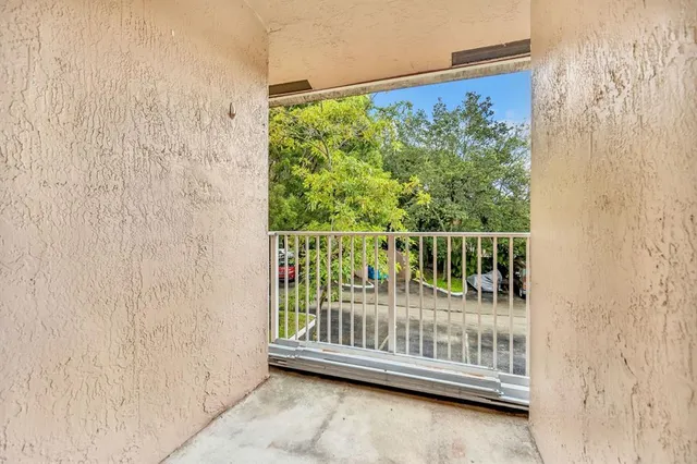a view of a porch with a floor to ceiling window