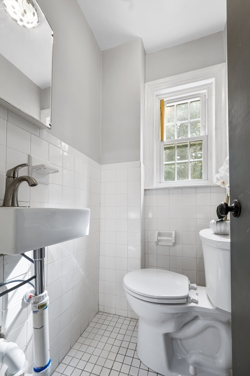 36 Melrose Street Worcester, MA 01605 - Photo 19 of 32 a bathroom with a sink a toilet and a window
