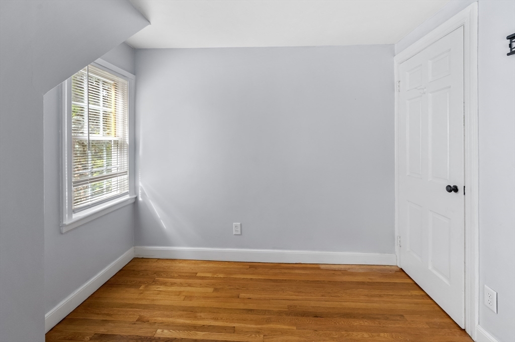 36 Melrose Street Worcester, MA 01605 - Photo 26 of 32 an empty room with wooden floor and windows