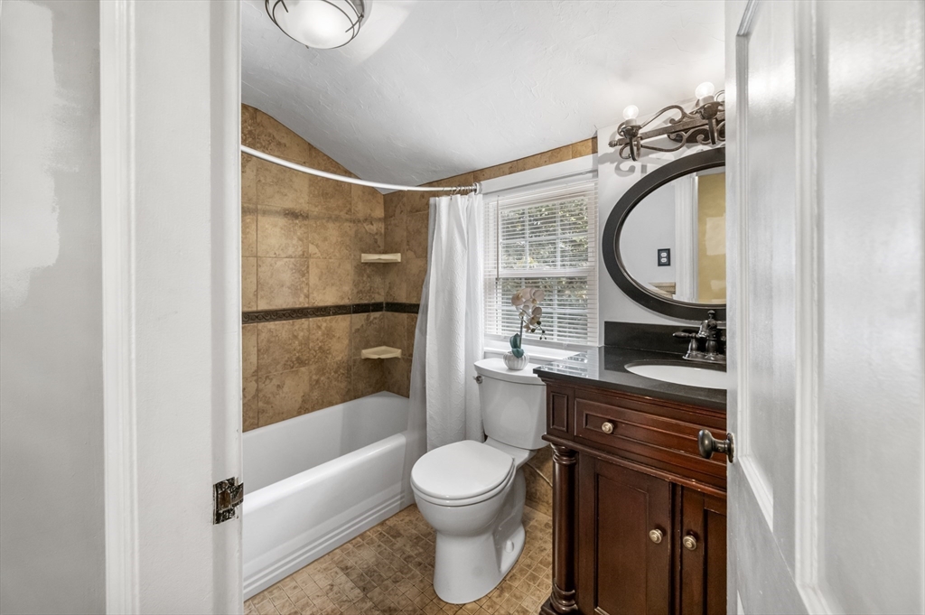 36 Melrose Street Worcester, MA 01605 - Photo 27 of 32 a bathroom with a toilet a sink and a mirror
