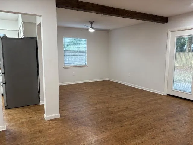 an empty room with fireplace and windows