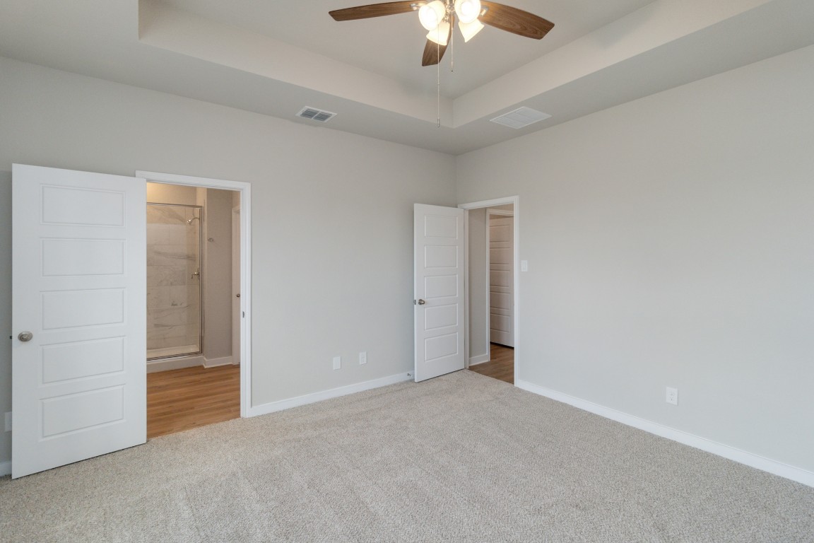 820 Staglin Street, Unit A Buda, TX 78610 - Photo 27 of 28 an empty room with chandelier fan