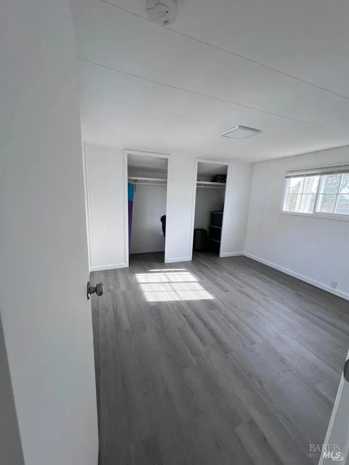 316 Pear Lane Santa Rosa, CA 95407 - Photo 14 of 17 an empty room with wooden floor and windows