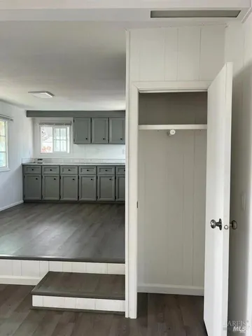 a view of an empty room with window and stairs