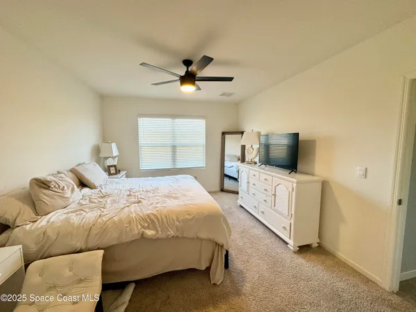 a bedroom with a bed and flat screen tv