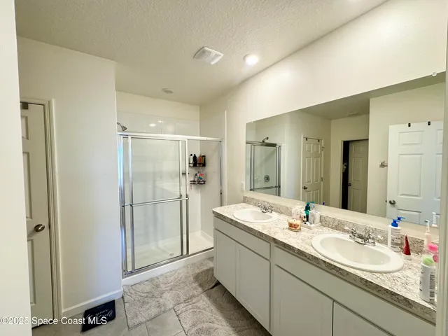 a bathroom with a double vanity sink mirror and double
