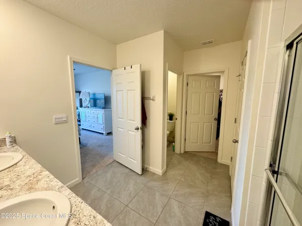 a view of a bathroom with a tub shower and a sink