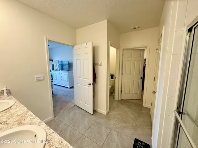a view of a bathroom with a tub shower and a sink