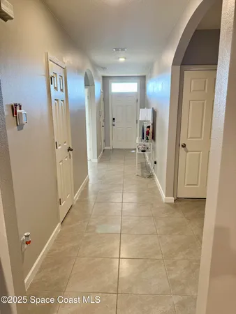 a view of a hallway with wooden shelves