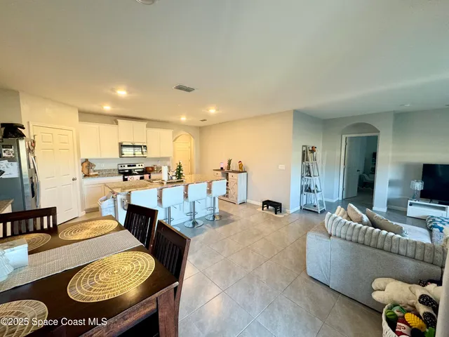 a living room with furniture and kitchen view