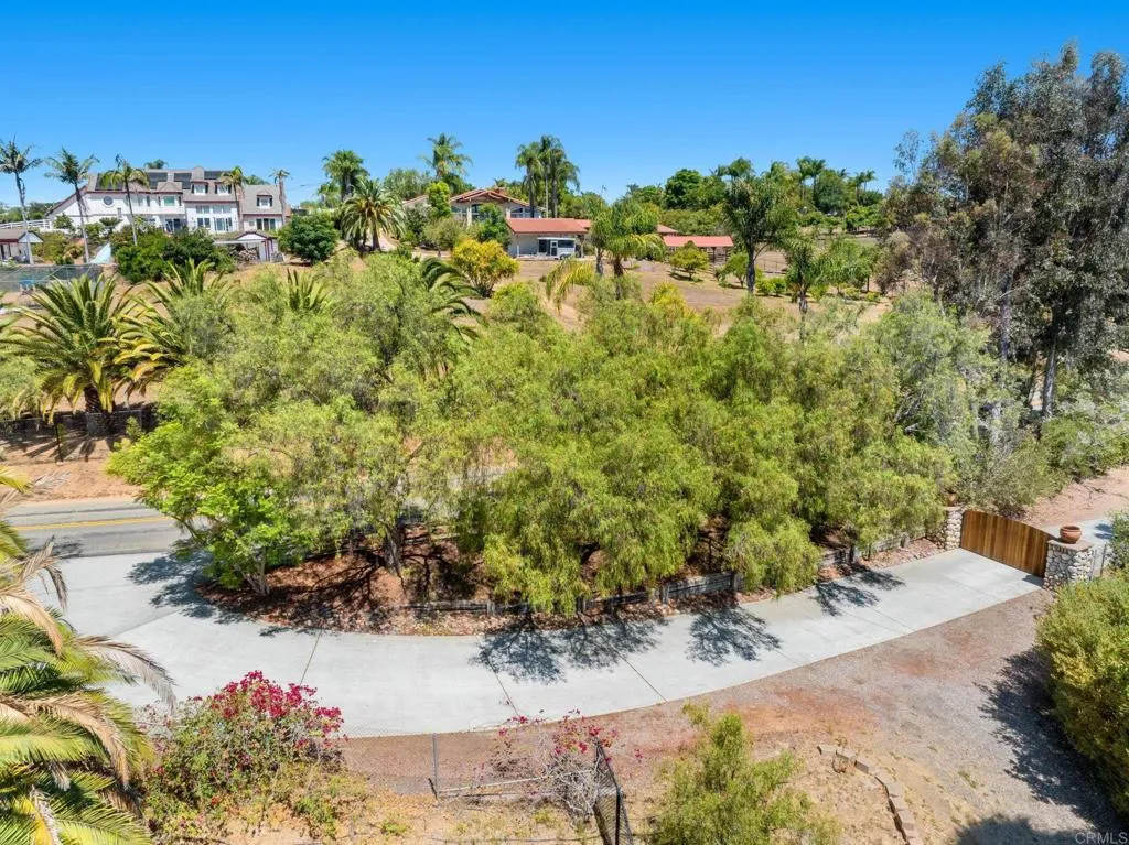 31619 Vía Puerta Del Sol Bonsall, CA 92003 - Photo 11 of 70 a view of a garden with a building in the background