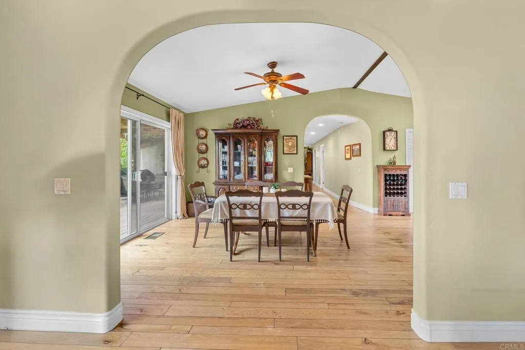 31619 Vía Puerta Del Sol Bonsall, CA 92003 - Photo 39 of 70 a view of a dining room with furniture and wooden floor