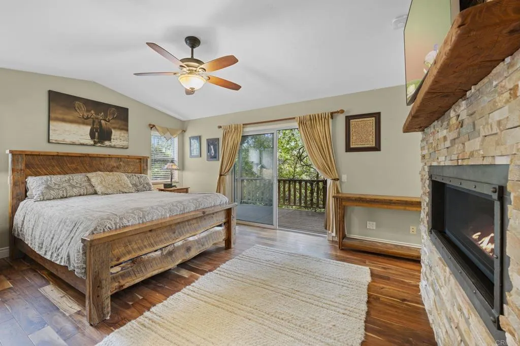 31619 Vía Puerta Del Sol Bonsall, CA 92003 - Photo 52 of 70 a bedroom with a bed and a fireplace