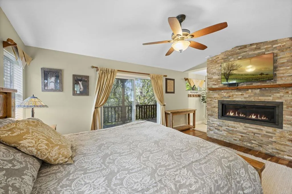 31619 Vía Puerta Del Sol Bonsall, CA 92003 - Photo 53 of 70 a bedroom with a bed and a fireplace