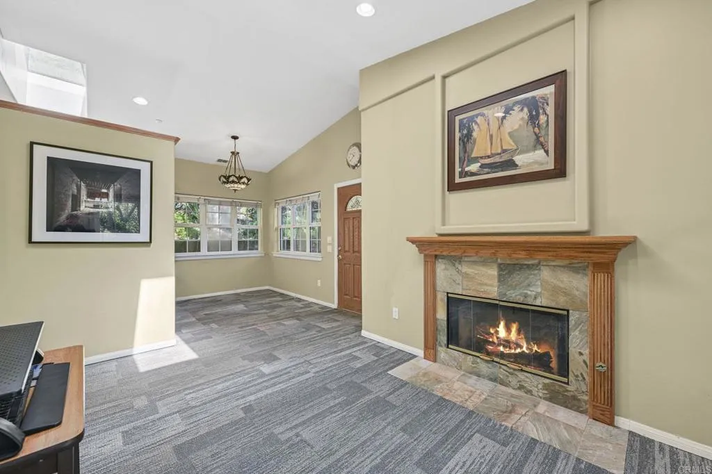 31619 Vía Puerta Del Sol Bonsall, CA 92003 - Photo 67 of 70 a view of an empty room with wooden floor and a fireplace