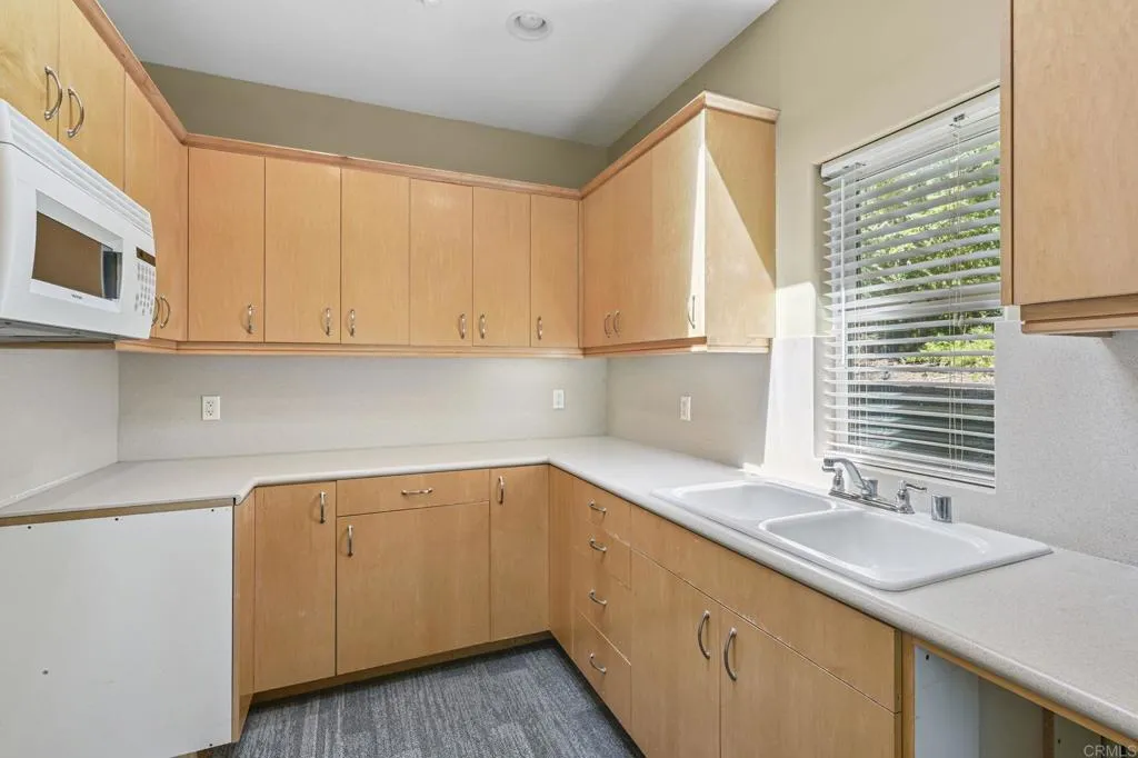 31619 Vía Puerta Del Sol Bonsall, CA 92003 - Photo 69 of 70 a kitchen with a sink stove and cabinets