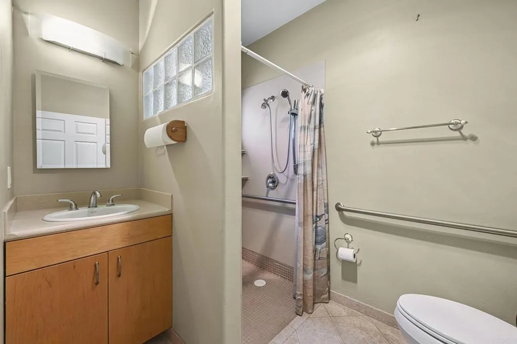 31619 Vía Puerta Del Sol Bonsall, CA 92003 - Photo 70 of 70 a bathroom with a granite countertop sink toilet and shower
