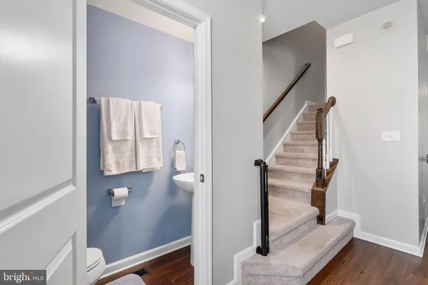 a view of entryway and hall with wooden floor