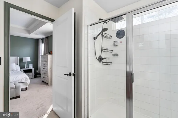 a bathroom with a shower and a mirror