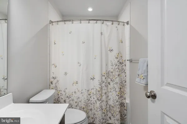 a bathroom with a shower curtain and a toilet