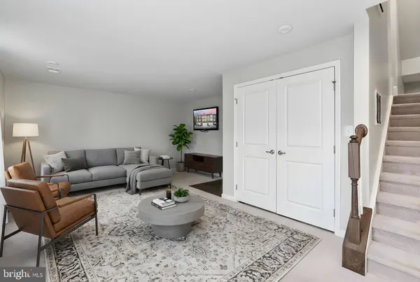 a living room with furniture and a rug