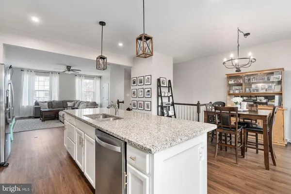 a kitchen with center island and stainless steel appliances
