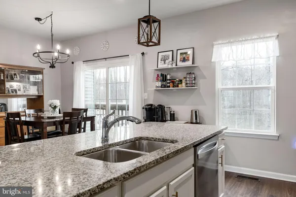 a kitchen with granite countertop a sink and center island