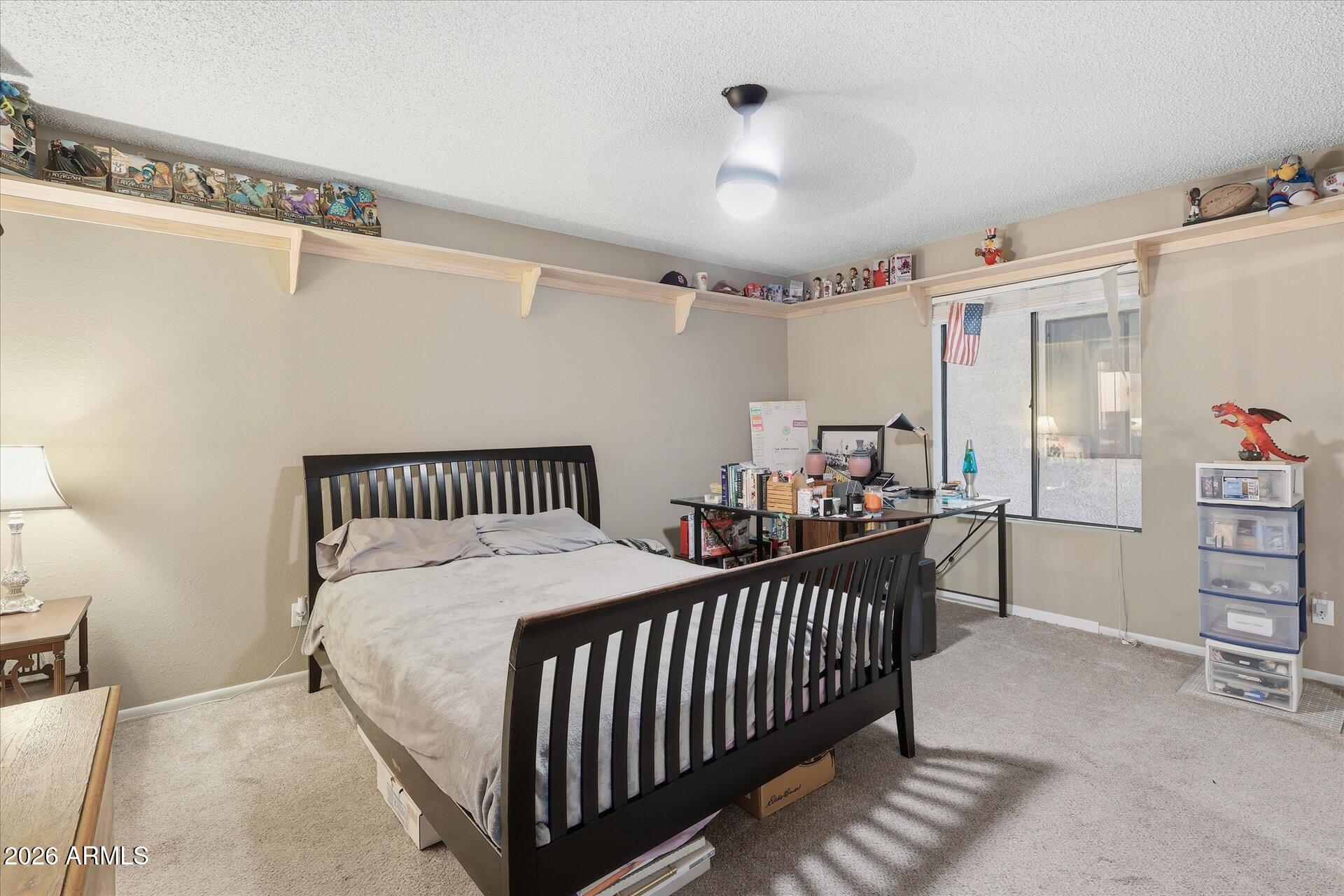 3270 South Goldfield Road, Unit 716 Apache Junction, AZ 85119 - Photo 13 of 36 a bedroom with a bed and a window