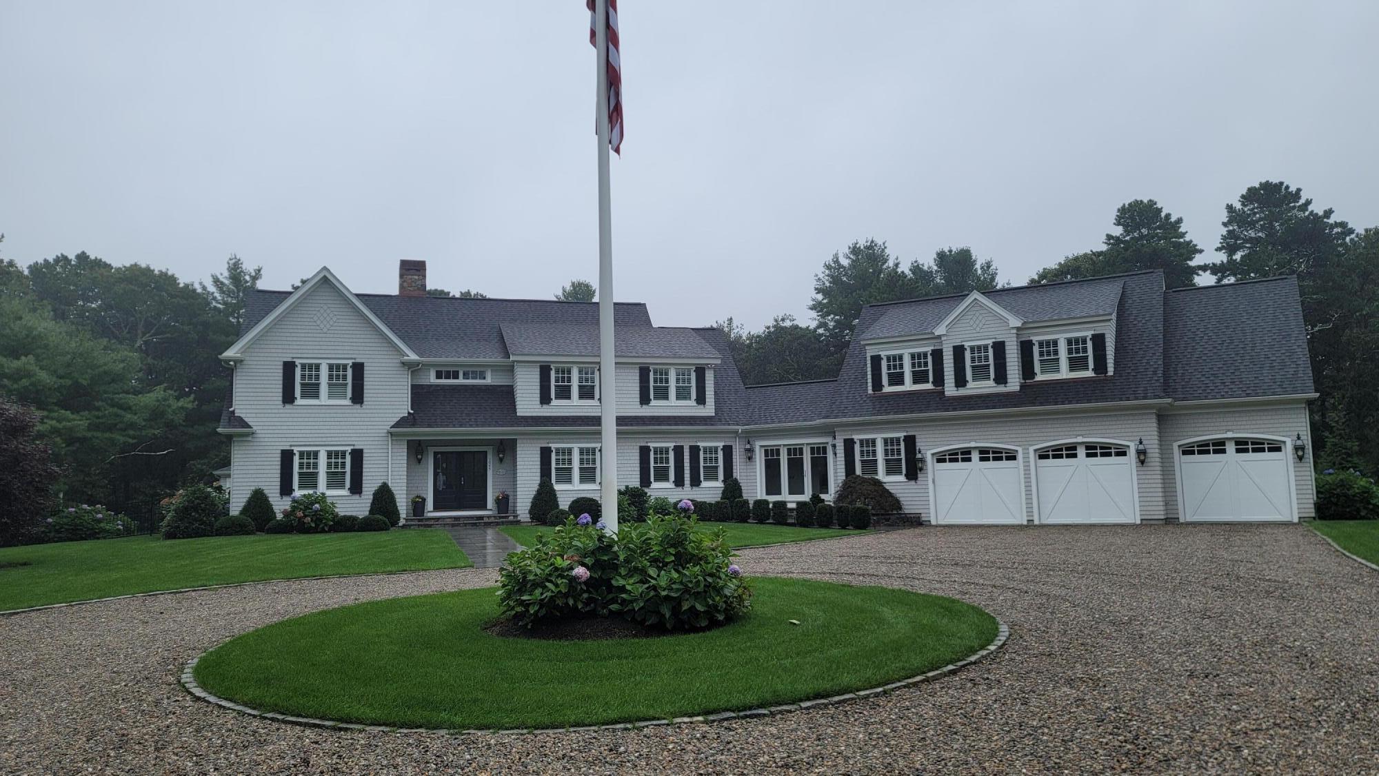 1045 Old Post Road Cotuit, MA 02635 - Photo 2 of 6 a front view of a house with a yard