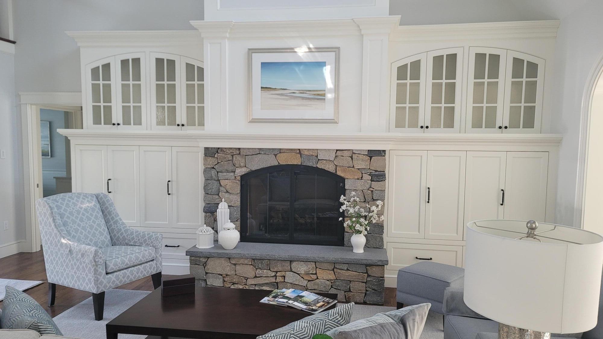1045 Old Post Road Cotuit, MA 02635 - Photo 4 of 6 a living room with furniture a fireplace and a table
