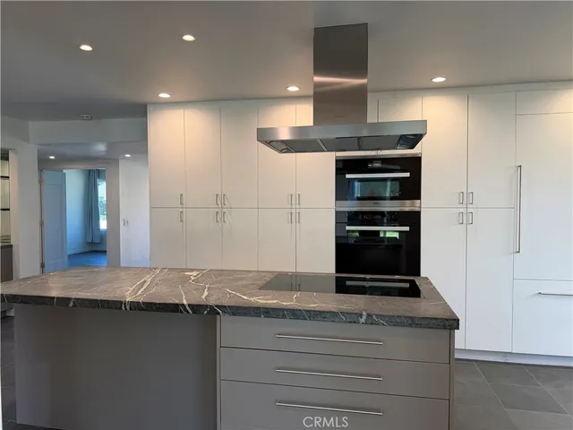 a bathroom with a shower and a chair