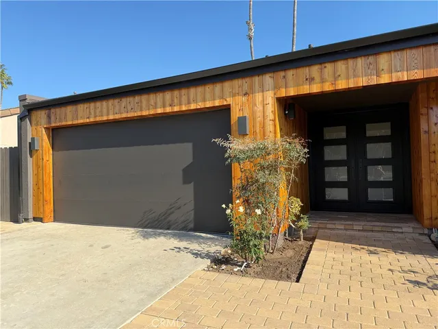 a kitchen with a stove a sink and a wooden floor
