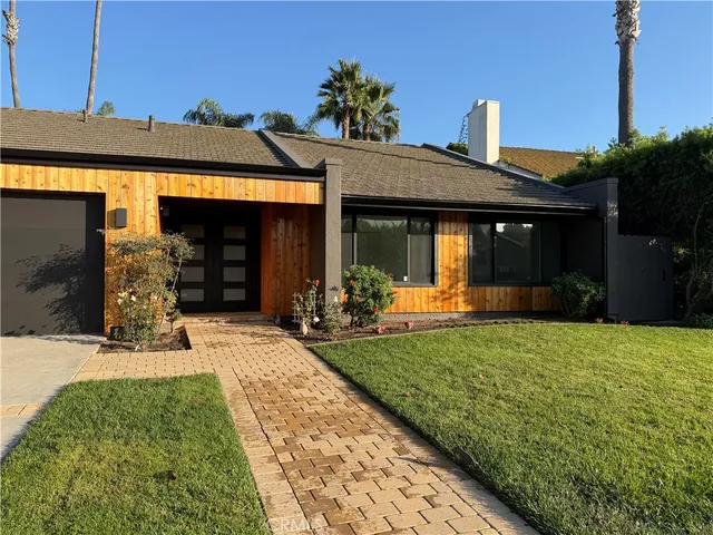 a kitchen with stainless steel appliances granite countertop a sink and a white cabinets